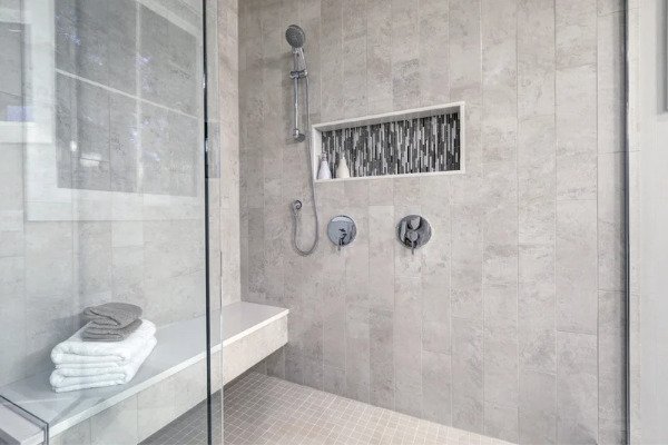 Image showing a glass walk-in shower in a bathroom in Tega Cay, SC. the tile is Ravenna almond ii porcelain mosaic.