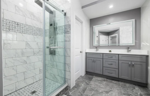 Image of a finished tub to shower conversion project in Fort Mill, SC. The image showcases a modern and elegant shower with a glass enclosure, featuring gray and white tiles and a sleek shower system. The conversion transformed the outdated bathtub into a stylish and functional shower, using high-quality materials and modern design techniques. The image displays the seamless and polished finish of the shower, adding a touch of sophistication and luxury to the bathroom.