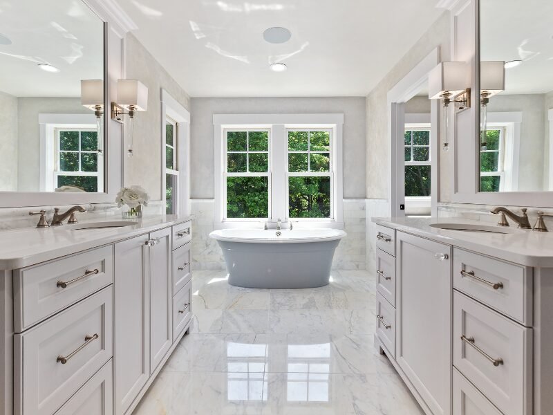 Newly renovated bathroom with a freestanding tub beneath a window in Fort Mill, SC.